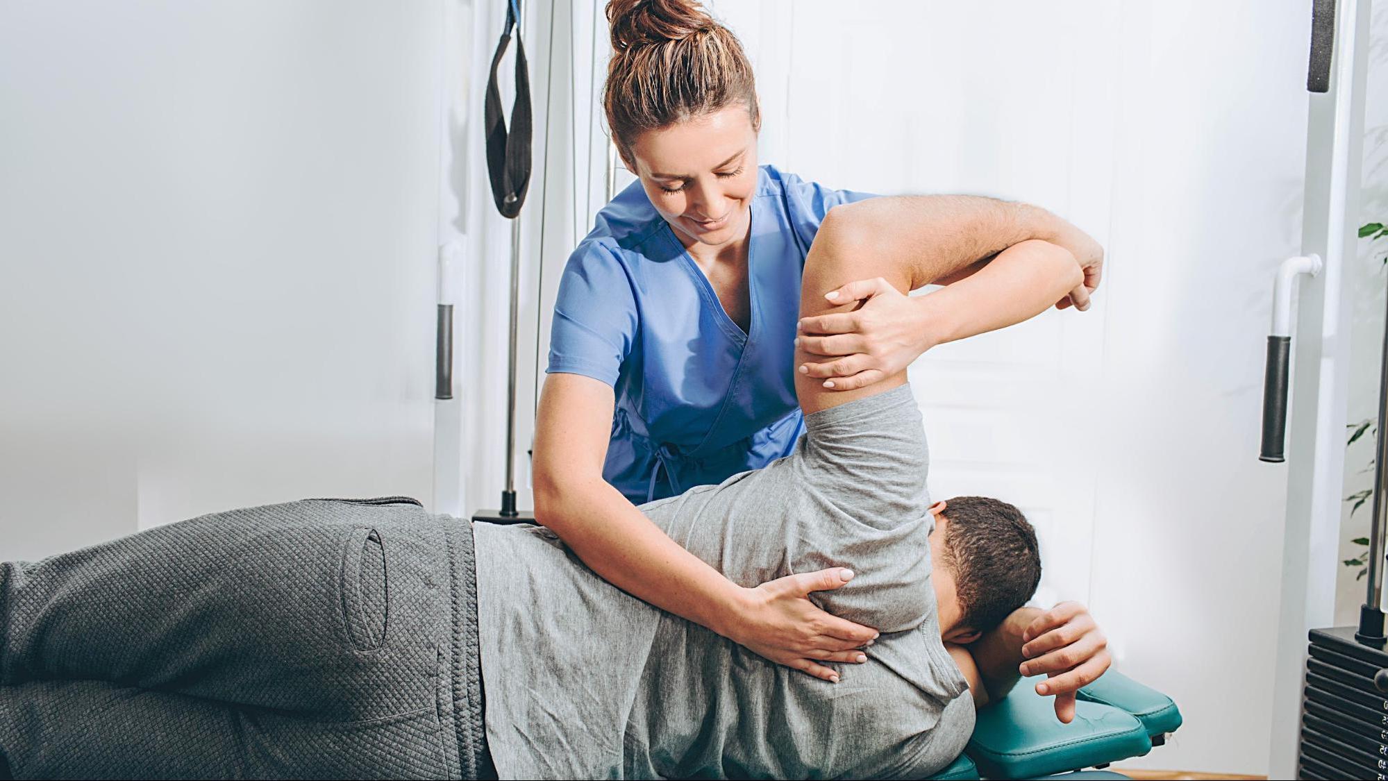 Chiropractor working with patient